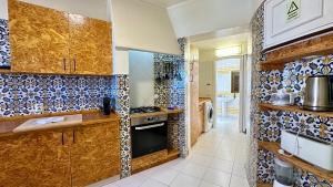 a kitchen with blue and white tiles on the walls at Beira Mar - Private Pool - 7 Guests - Albufeira in Albufeira