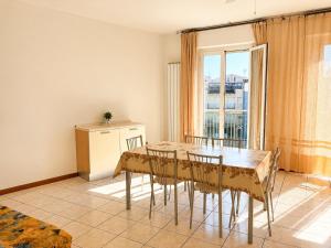 a dining room with a table and chairs at De Amicis Sea Home in Gabicce Mare