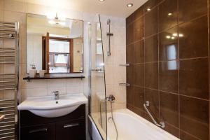 a bathroom with a sink and a shower and a tub at Kahlua Bay Apartments in Hersonissos