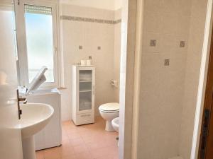 a bathroom with a toilet and a sink at De Amicis Sea Home in Gabicce Mare