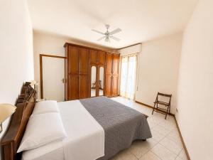 a bedroom with a bed and a ceiling fan at De Amicis Sea Home in Gabicce Mare