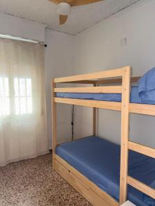 two bunk beds in a room with a window at La Barraca in Gandía