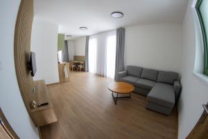 a living room with a couch and a table at Lebeco Apartman in Kolárovo