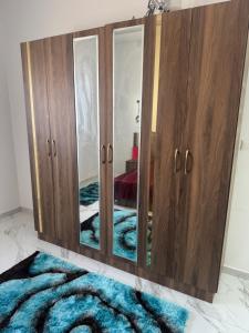 a large wooden cabinet with mirrors in a room at Venice Private Retreat Tripoli, Libya in Tripoli