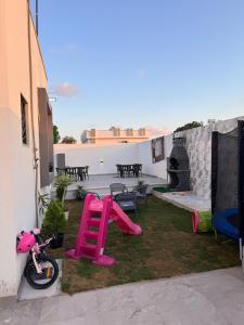 a backyard with a pink slide and a playground at Venice Private Retreat Tripoli, Libya in Tripoli +13 photos