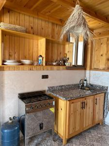 a kitchen with a stove and a counter top at Blue Drift in Imsouane