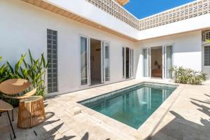 a swimming pool in the backyard of a house at Villa Candi - Stylish Tropical Pool Villa in Ungasan