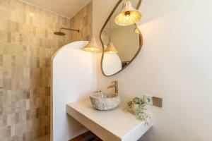 a bathroom with a sink and a mirror at Villa Candi - Stylish Tropical Pool Villa in Ungasan +18 photos