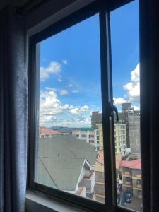 a window with a view of a city at Ruaka Karington Studio in Ruaka