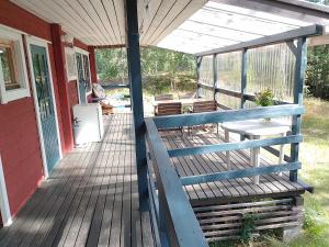 a porch of a house with chairs and a refrigerator at Takalahti Lodge in Puumala +3 photos