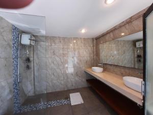 a bathroom with a sink and a shower at Serenity Nirvana Palace Jimbaran - Near Uluwatu in Jimbaran +29 photos
