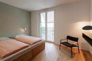a bedroom with a bed and a desk and a chair at Geneva Youth Hostel in Geneva +18 photos