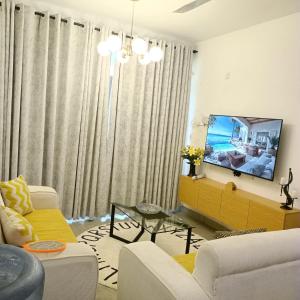 a living room with a couch and a tv at Zurilyn Crib in Malindi