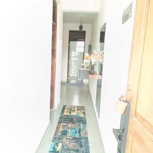 a hallway with a rug on the floor next to a door at Zurilyn Crib in Malindi