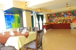 a dining room with a table and a painting on the wall at Burqito International Hotel in Āwasa