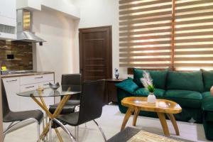 a living room with a green couch and a table at Halil Bey Luxury Apartments in Kavála