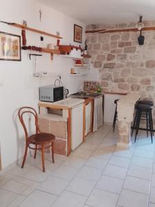 a kitchen with a counter and a table and chairs at Slavko in Hvar