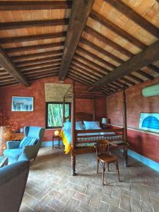 a bedroom with a bed and a couch in a room at Residenza termale Monte Santo in San Casciano dei Bagni +8 photos