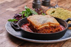 a plate of food with a sandwich and bread at The Amble Inn - The Inn Collection Group in Amble
