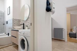 a bathroom with a washing machine and a sink at La Casetta di G&G in Varese