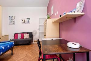 a living room with a table and a purple wall at La Casetta di G&G in Varese