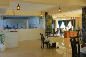 a kitchen and dining room with a table and chairs at Burqito International Hotel in Āwasa