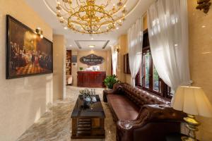 a living room with a couch and a chandelier at Vina Classic Hotel in Hue