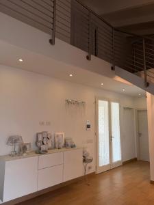 a kitchen with white cabinets and a ceiling at Villa Forni in Cesenatico