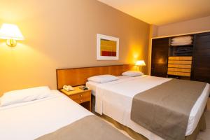 a hotel room with two beds in a room at Itapura Eco Resort in Atibaia +77 photos