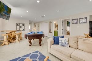 a living room with a couch and a pool table at 7000 - Serenity Sands in Whalebone +67 photos