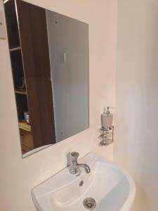 a white sink in a bathroom with a mirror at Gweth Haven Homes in Nakuru +18 photos
