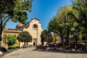 a large building with a clock tower in front of it at Hostel Santa Monaca in Florence