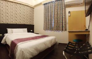 Postel nebo postele na pokoji v ubytování King Town Hotel