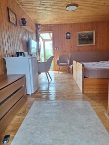 a bedroom with a bed and a refrigerator and a table at Agroturism Jures in Ljutomer