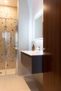 a bathroom with a sink and a shower at Bed & Bricks in Reggio Emilia