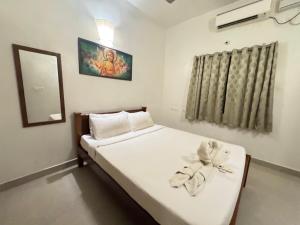a bedroom with a bed with a mirror and a window at Villa Shakthi in Pondicherry +46 photos