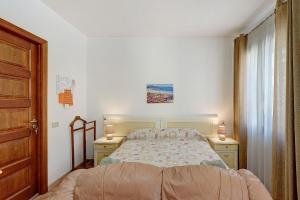 a bedroom with a bed and two night stands at Attico Bella Vista in Siniscola