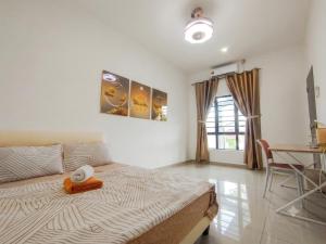 a bedroom with a bed and a table in it at Golden Paradise Fully Aircond in Kuantan
