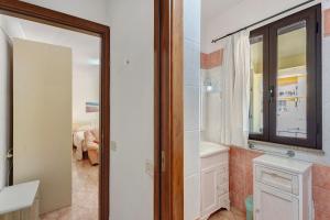 a bathroom with a tub and a sink and a mirror at Attico Bella Vista in Siniscola +93 photos