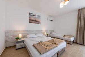 a bedroom with two beds in a room at Apartments Sarić in Bar