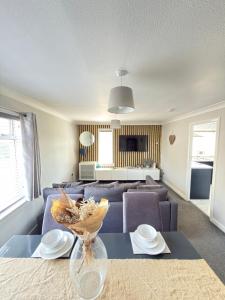 a living room with a couch and a table at Erskine Apartment in Erskine