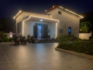 a house with motorcycles parked in front of it at night at CoNa Homestay in Ðồng Khê Sâu