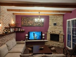 a living room with a couch and a fireplace at Villa Mondi in Durrës