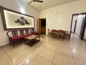 a living room with a couch and a table at Villa Shakthi in Pondicherry