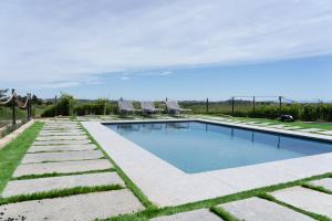 a swimming pool in a yard with grass at Da Elvira in Costigliole dʼAsti +69 photos