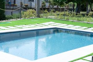 a swimming pool in the middle of a yard at Da Elvira in Costigliole dʼAsti