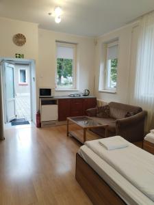 a living room with a couch and a table at Klaipeda INN Private Parking and Kitchen in Klaipėda