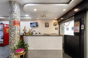 a kitchen with a counter in a room at Hotel Aditya Grand in Guntūr