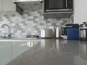 a kitchen with a counter top with appliances on it at Sunset Dunes in Cape Town +6 photos