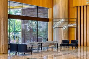 a lobby with chairs and tables in a building at Divani Caravel in Athens